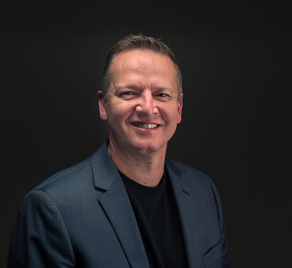 A woman sitting on a stool next to a podium